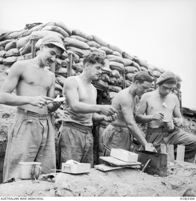 Lunch in the open air outside their sandbagged dugout is enjoyed by ...