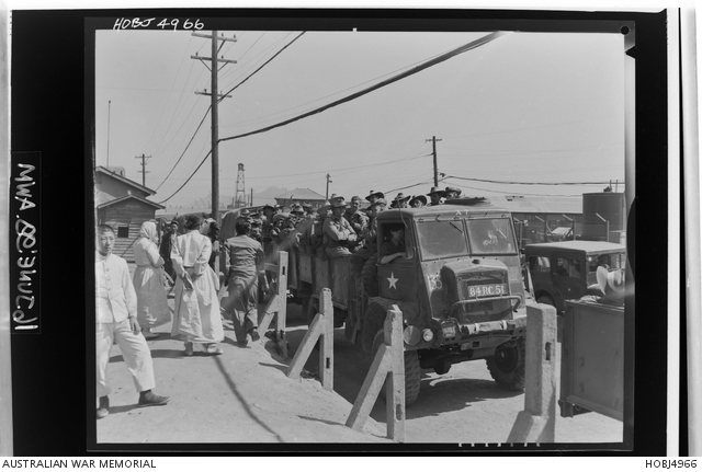Pusan, Korea. 2 April 1954. A few citizens of Pusan watch as a convoy ...