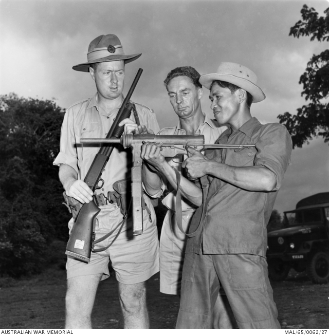 An irregular Vietnamese soldier tries out a US Army automatic weapon ...