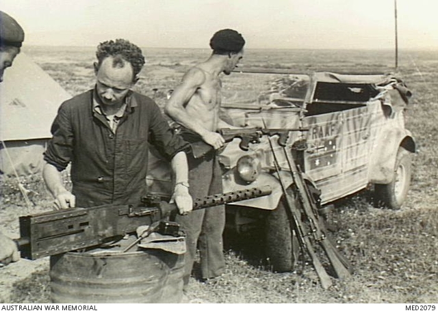 Tunisia. c. May 1943. RAAF ground defence personnel checking weapons to ...