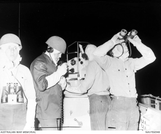 Lookouts at night action stations on the Gun Direction Platform (GDP