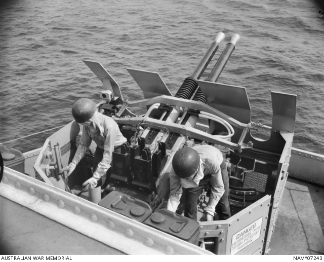 A gun crew, loader and trainer, operating a 40 mm Bofors anti-aircraft ...