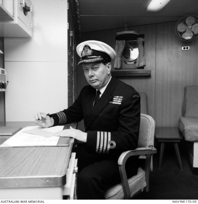 Portrait of 150 Captain (Capt) Ian Malcolm Burnside at his desk on