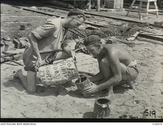 THURSDAY ISLAND, QLD. 1943-12-23. POURING OUT PAINT FOR USE ON THE HULL ...