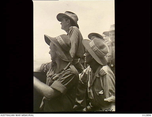 OFF LABUAN ISLAND, BORNEO. 1945-06-10. MEMBERS OF A RAAF PARTY SCAN THE ...