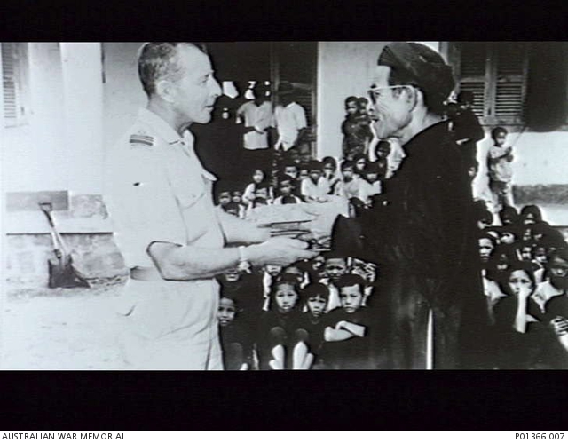 The village chief presents Chaplain David Pritchard RAAF with a gift in ...