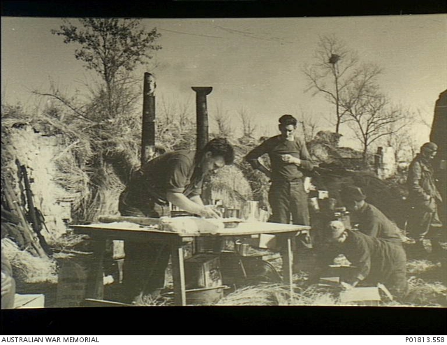 Korea, c. 1951-02. Working on a trestle table at a camp kitchen set up ...
