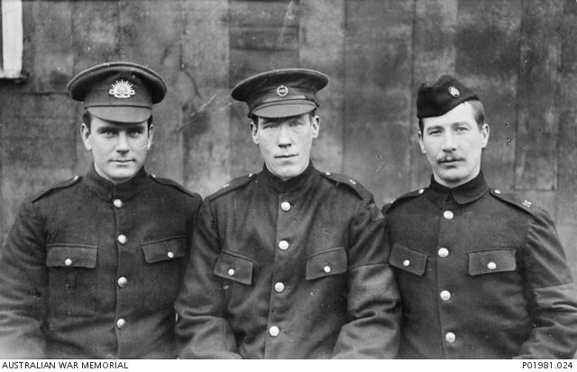 Informal portrait of three allied Prisoners of War (POW) at a POW Camp ...