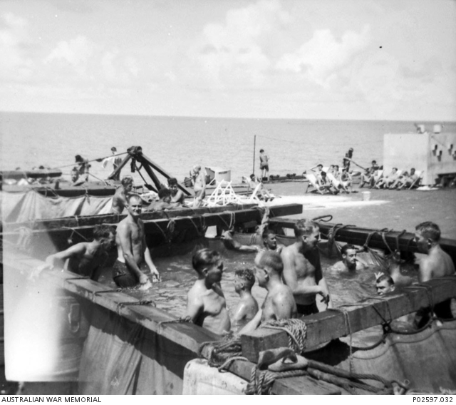 Former Prisoners of War (POWs) enjoy a swim in temporary swimming pools