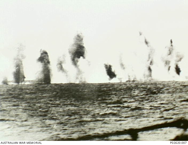 Java Sea. 15 February 1942. Bomb spray obscures the British cruiser HMS ...