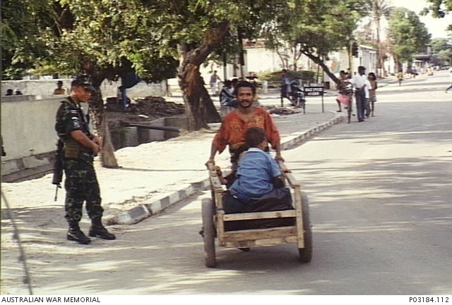 Dili, East Timor. 13 November 1999. A Thai soldier watches as a ...