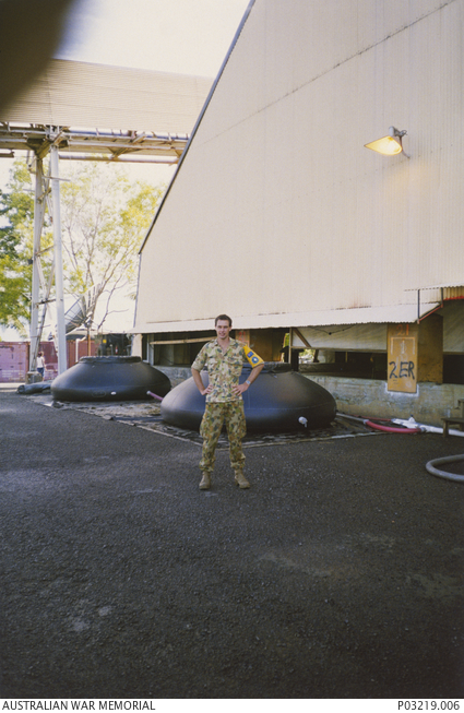 Informal portrait of Signaller Jason Hanel standing in front of two ...