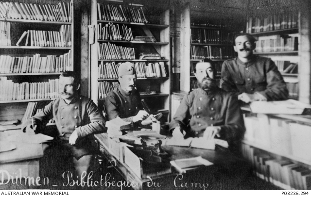 Group portrait of four unidentified Prisoners of War (POW) in the ...