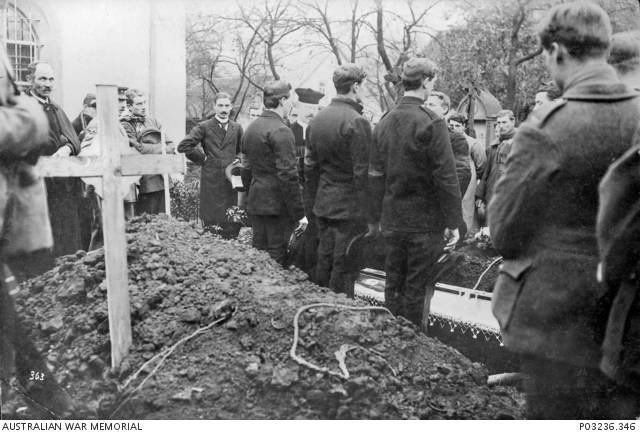 Outdoor portrait of a group of Prisoners of War (POW) at the burial of ...