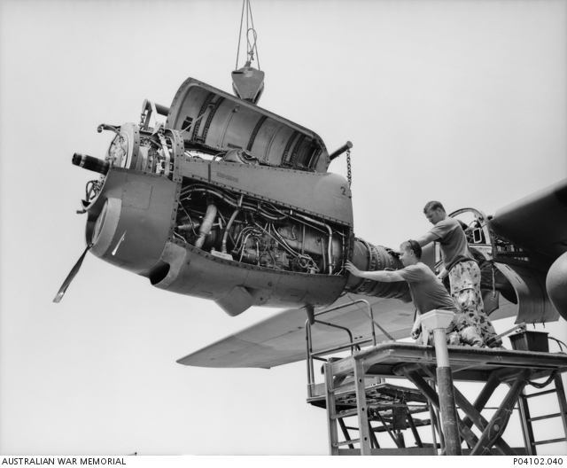 Two ground crew members from 36 Squadron RAAF complete maintenance on ...