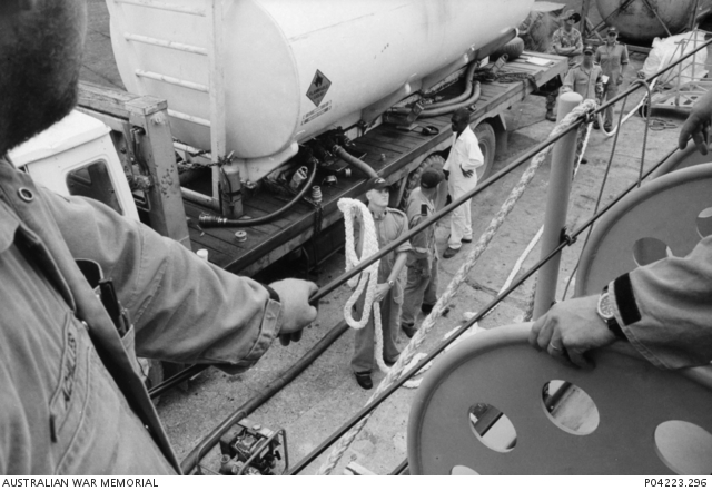 Refuelling HMAS Diamantina [II] at Honiara port. Unidentified sailors ...