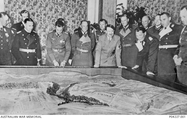 Adolf Hitler And His Generals Surveying A Relief Map During A Briefing 