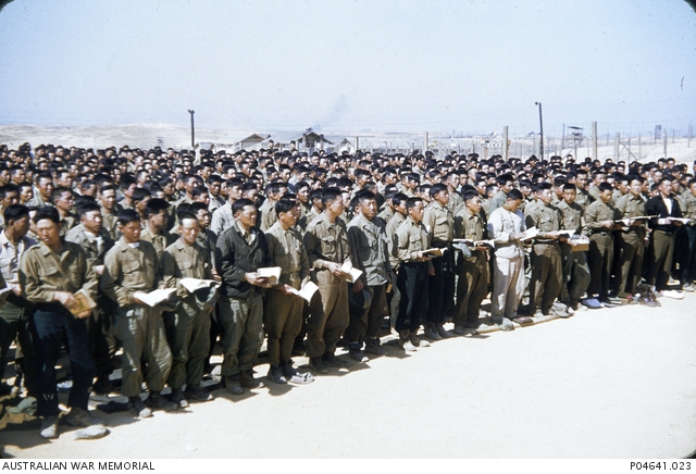 North Korean prisoners of war (POWs) singing hymns at Nonsan POW camp ...