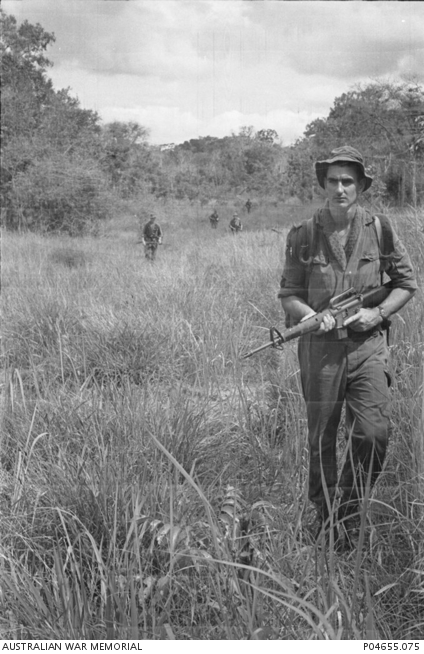 With his finger safely resting above the trigger of his M16 rifle ...