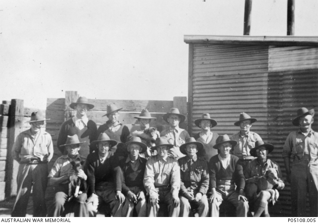 Group portrait of servicemen stationed at Prisoner of War (POW) Camp No ...