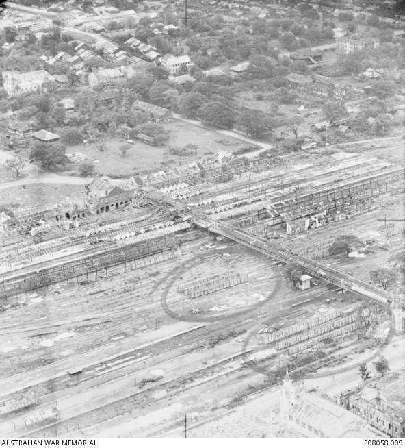 Low level aerial photograph of Rangoon railway station during a raid by ...