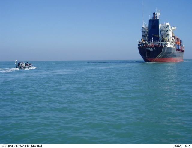 A boarding party, deployed on a RHIB from HMAS Parramatta, approaching ...