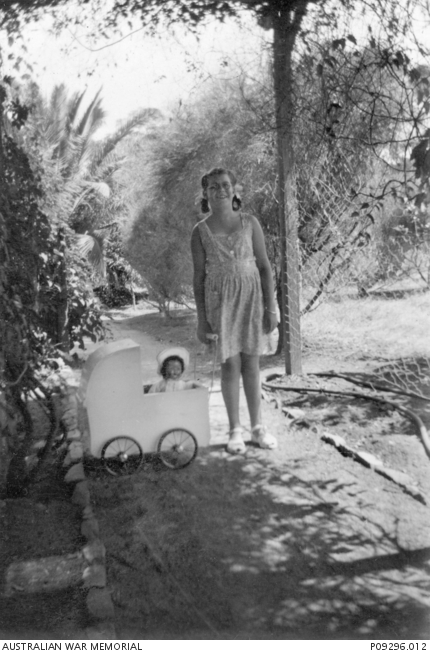Wendy Rudduck with pram in use. | Australian War Memorial
