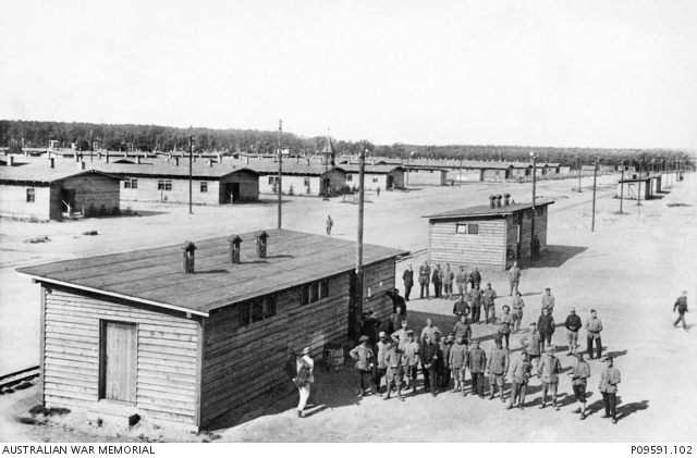 A group of unidentified prisoners of war (POW) outside a building at ...