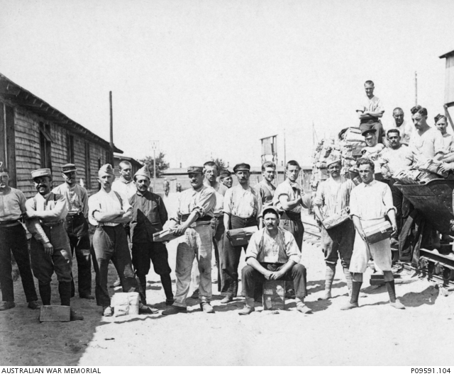 A large group of unidentified prisoners of war (POW) unloading material ...