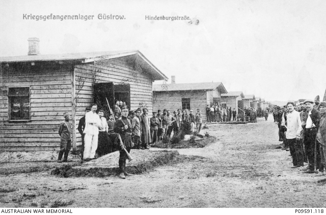 A large group of unidentified prisoners of war (POW) and a German guard ...