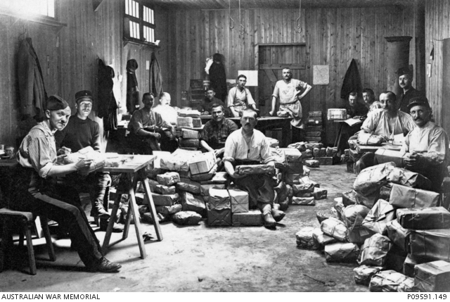 A group of unidentified allied prisoners of war (POW) sorting parcels ...