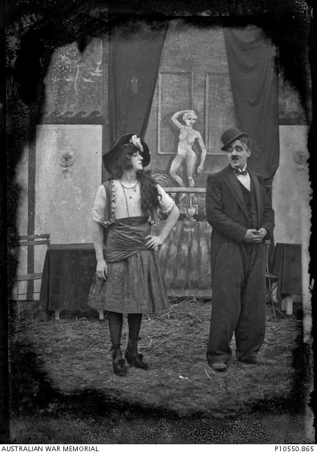 Portrait of two unidentified members of a theatre troupe in front of a ...