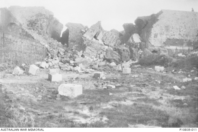 Damaged buildings (?town walls). This image forms part of a collection ...