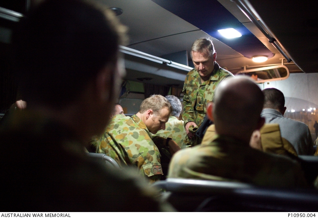 In the early morning ADF personnel travel on a bus to the Reception ...