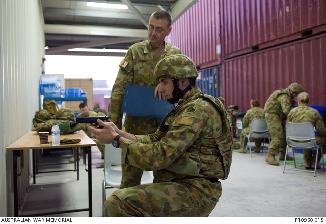 ADF personnel undertake weapons loading and unloading training at a ...