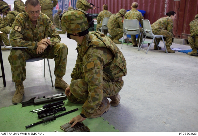 ADF personnel undertake weapons loading and unloading training at a ...