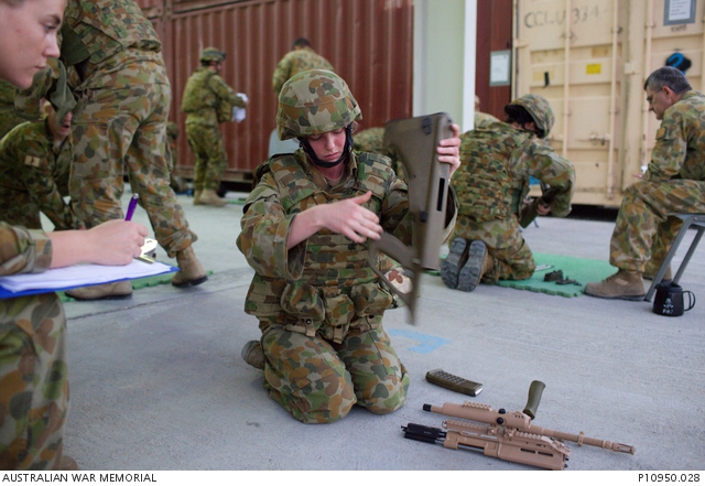 ADF personnel undertake weapons loading and unloading training at a ...