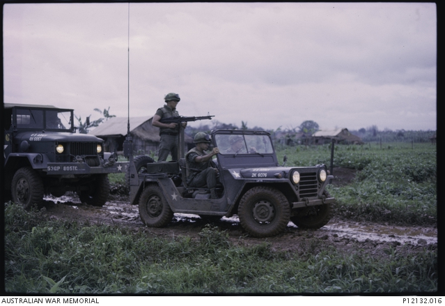 US Army Jeep With M60 Machine Gun Mounted At Rear On The Road Between 