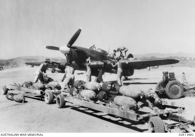 India. 1944-12-12. A bomb train pulls up, to a RAF Hawker Hurricane ...