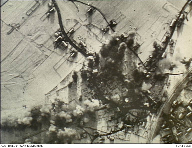Rhineland, Germany. 1944-12-23. Bombs bursting across enemy troop and ...