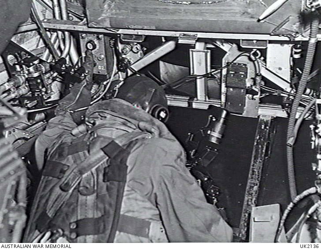 England. C. 1944-10. Crew member installing a F-24 camera in a bomber ...