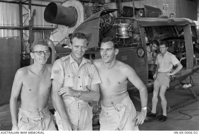 Three engine fitters of No 9 Squadron, RAAF, stand together in the ...