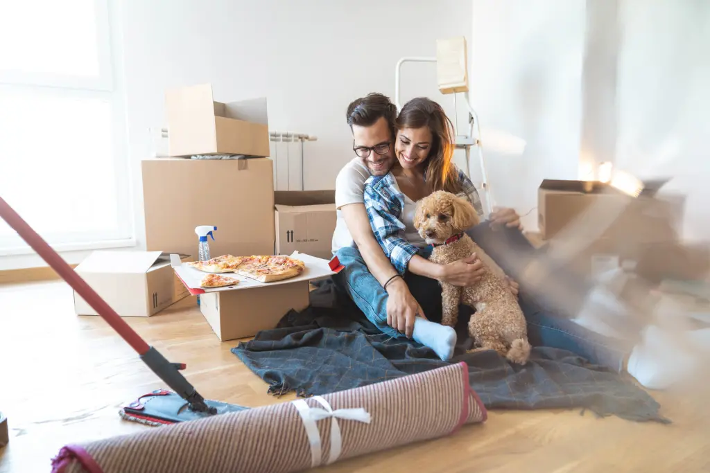 Family members sitting together and talking in bright living room of new home