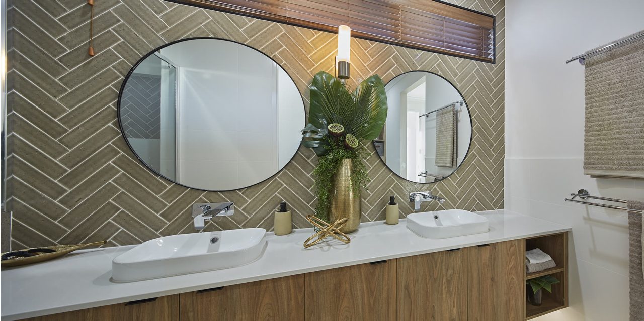 Two round mirrors used as decorative glass features above a bathroom vanity.
