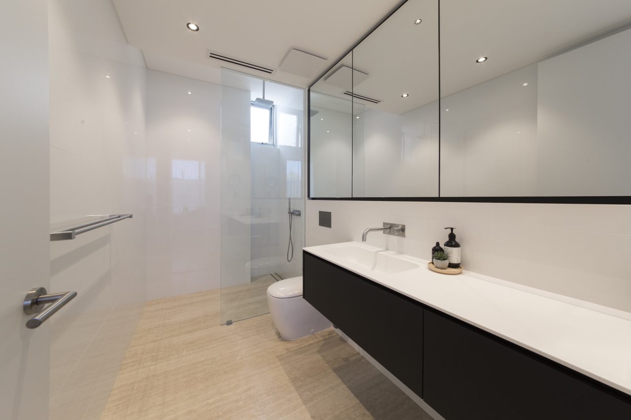 Modern bathroom with a frameless glass shower screen.