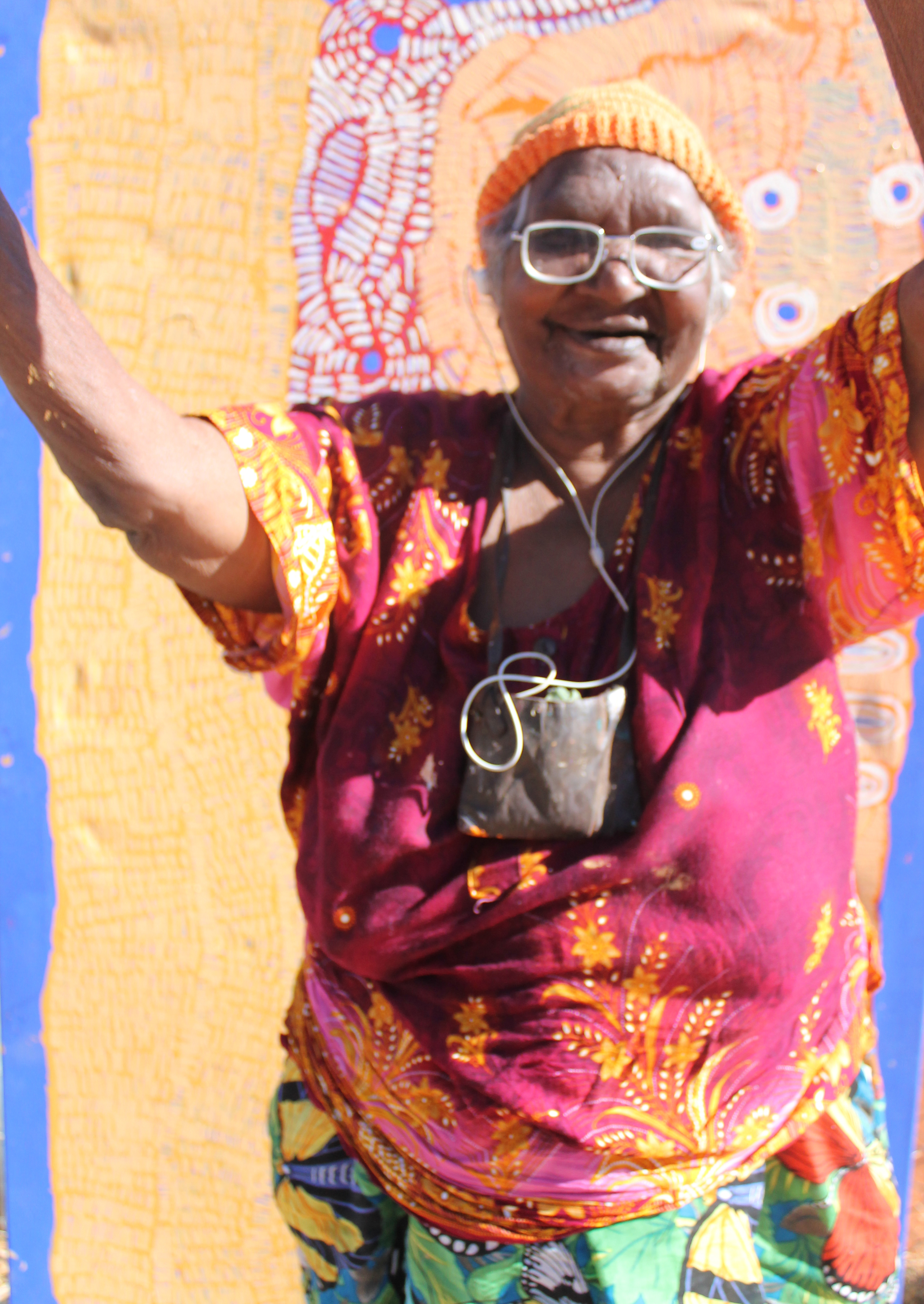 Doris Bush Nungarrayi, celebrating her completed artwork, 2017. Image courtesy of Papunya Tjupi Arts.