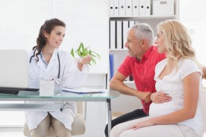 pregant woman at the doctors with her partner