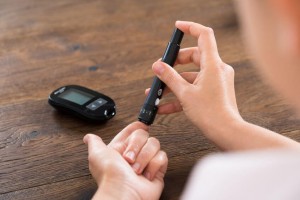 Close-up Of Woman Hands Testing High Blood Sugar With Glucometer