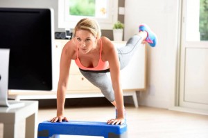 woman exercising in front of TV