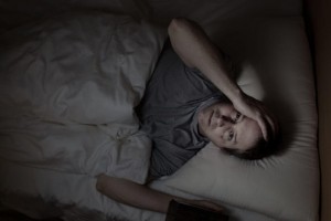 mature man in bed, having trouble sleeping